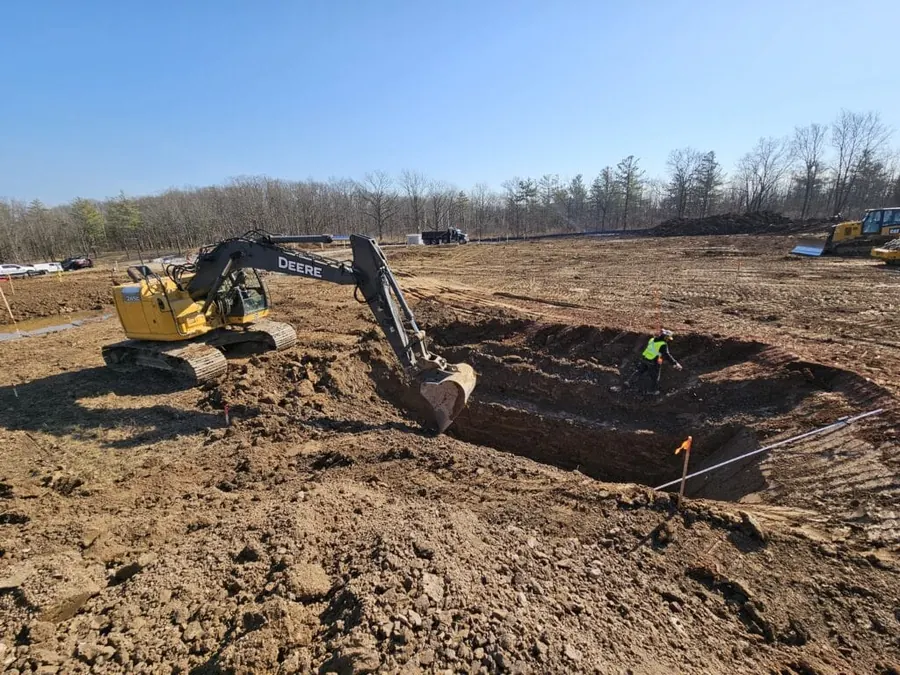 Excavator digging a trench