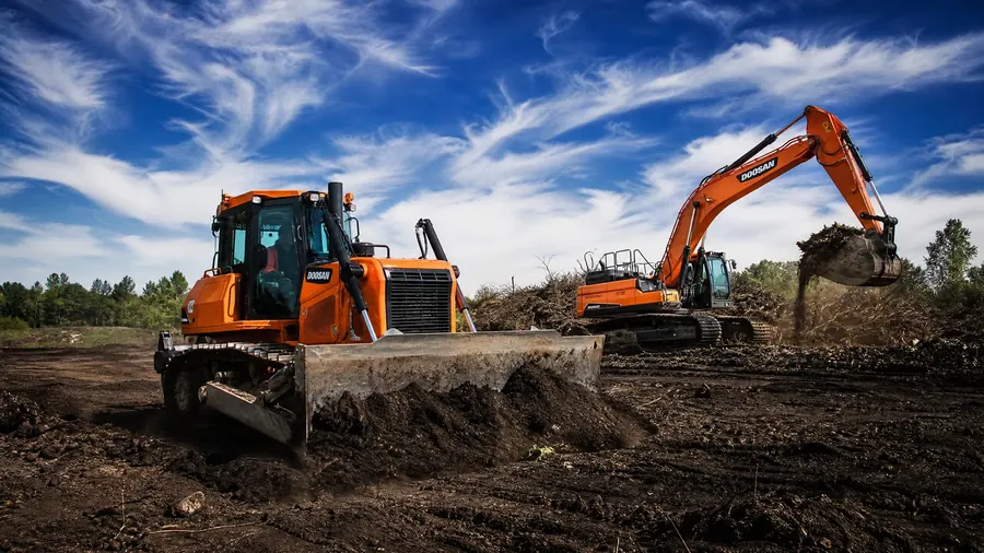 MXC dozer and excavator working on a site