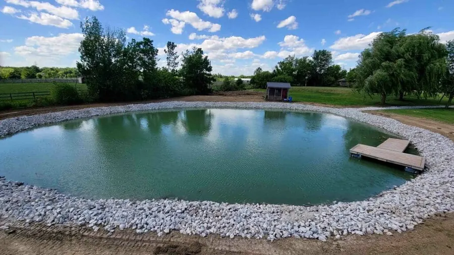 Pond with rock shoreline and a dock