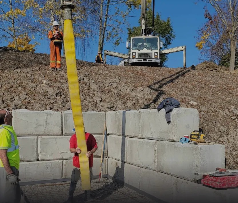 Interlocking concrete block wall being set