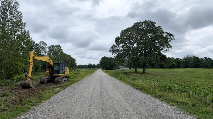 Gravel laneway with excavator
