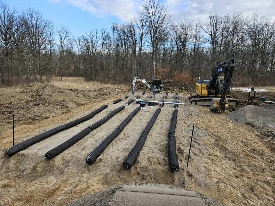 Septic leaching bed pipe laid out in stone