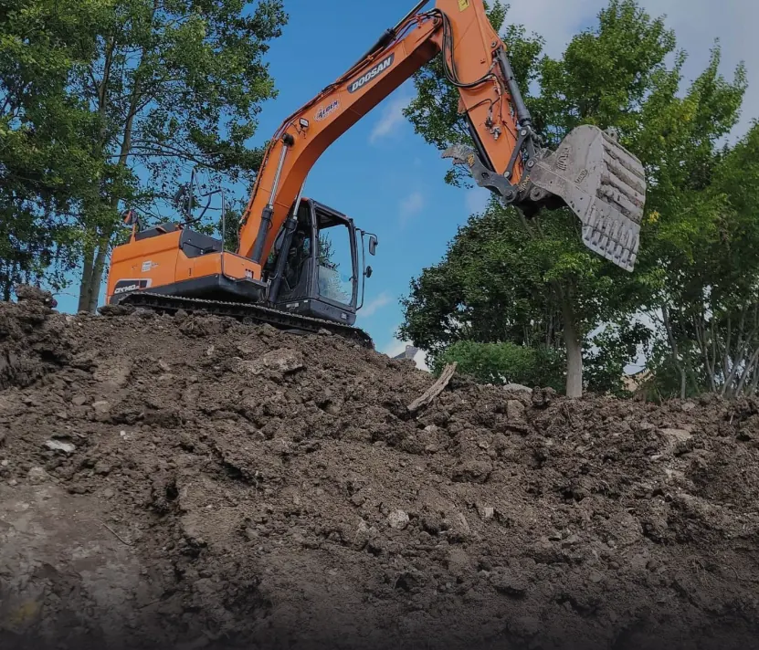 Orange excavator moving dirt